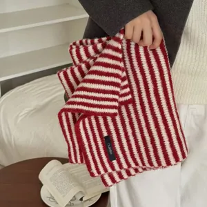 Detailed view of a retro red and white striped knitted scarf for winter warmth