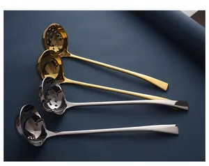 Detailed view of long handle stainless steel soup and slotted spoons in gold and silver.
