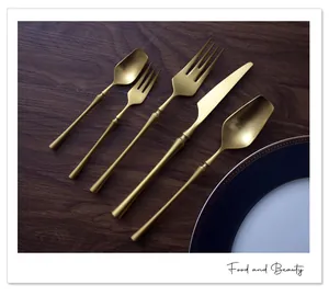 Professional close-up of matte gold 304 stainless steel cutlery set with slender handles