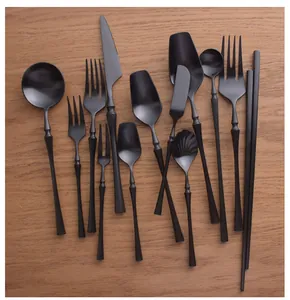 Assorted black brushed 304 stainless steel cutlery set displayed on a wooden surface