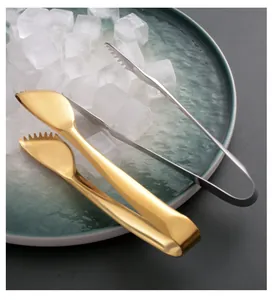 Detailed view of gold and silver stainless steel tongs with serrated edges for ice cubes.