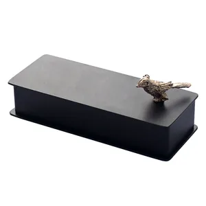 Modern matte black stainless steel toothpick box featuring a decorative golden bird figurine.