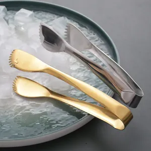 304 stainless steel serrated food tongs for ice and BBQ on green plate