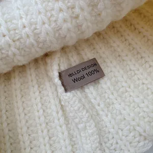 Detailed macro shot of 100% pure wool knit balaclava showing fabric texture and label