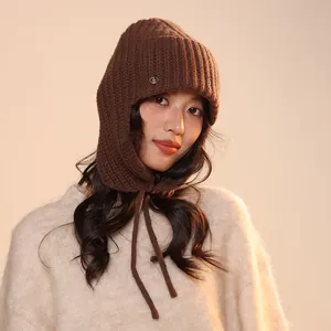 Detail shot of a brown wool knitted balaclava with warm studio lighting on model