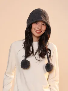 Charcoal grey pure wool knit elf hood with decorative dual pom-poms worn by a model