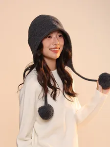 Asian model wearing dark grey wool elf pumpkin knitted hat with pom-poms detail view