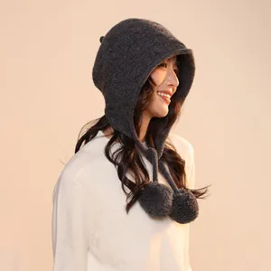 Side profile detail showing the dark grey knitted wool elf hat with decorative pom-poms