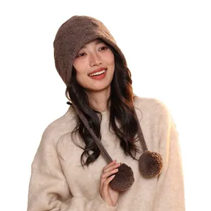 Elegant wool elf pumpkin knit hat with pom-poms for winter, modeled on a white background.