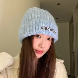 Soft light blue knitted winter beanie featuring Hello Kele embroidery for warm style