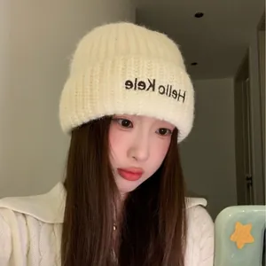 Soft and warm cream-colored knitted beanie hat for winter cold protection.