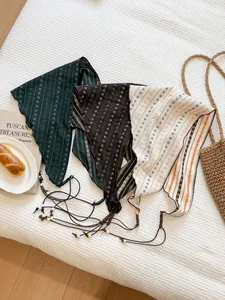 Set of three retro floral triangle headscarves in dark green, brown, and cream tones.