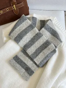 Detail shot of a soft gray and white striped knit neck warmer for winter.