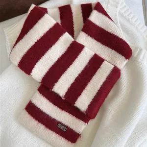 Close-up of a cozy red and white striped knitted scarf featuring a soft wool texture.