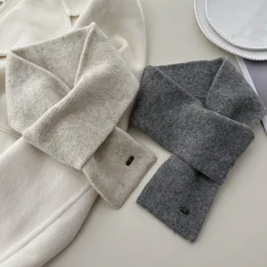 Two soft knitted cross scarves in light and dark gray for winter warmth