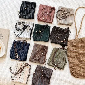 Assorted vintage patterned cotton linen neckerchiefs with drawstring beads and straw bag