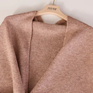 Detail view of a soft solid color wool blend cross-knit shawl with premium texture