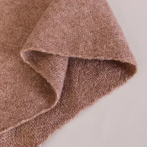 Detailed view of camel wool blend knitted shawl showing thick texture and soft drape