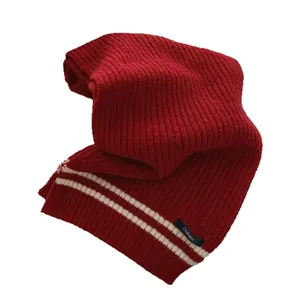 Vintage red knitted scarf with classic white stripes in warm academy style for winter season