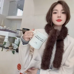 Stylish brown faux fur winter scarf worn by a model in a cozy cafe setting