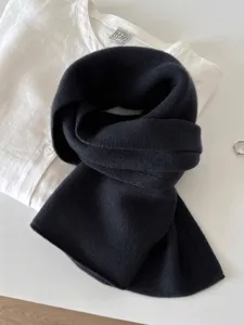 Detailed view of black 100% pure wool knitted scarf showing soft and warm texture