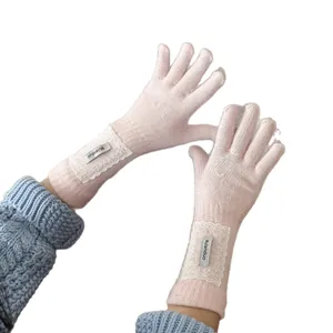 Elegant light pink long knitted gloves with delicate lace trim for women's winter
