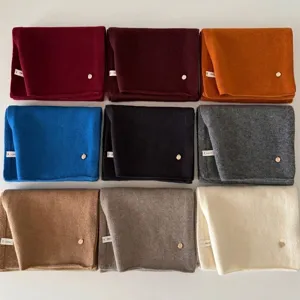 A variety of 100% wool knitted scarves in nine classic colors for winter warmth