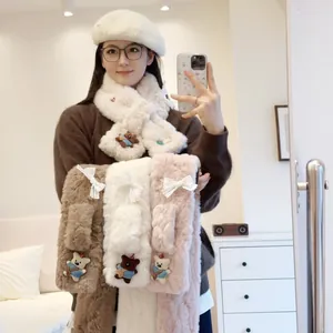 Detail view of plush faux fur scarves with cute bear and bow decorations in multiple colors