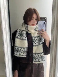 Close-up detail of the vintage snowflake jacquard pattern on a soft knit winter scarf