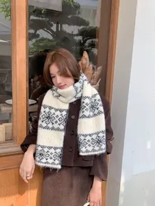 Cozy snowflake pattern knitted scarf shown on a model in a lifestyle setting