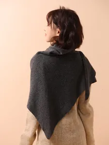 Detail view of a 100% Australian wool knitted triangular shawl wrap in dark gray