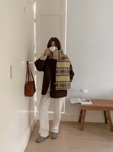 Full view of a woman wearing a beige Korean retro snowflake jacquard knit scarf