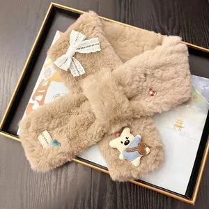 Detail of cute beige plush bear scarf with white lace bow and warm cross-neck design