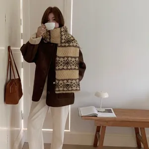 Cozy retro knit scarf with snowflake jacquard pattern worn by a model in winter style