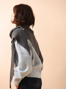 Model wearing 100% Australian wool dark grey triangle shawl over a light blue sweater