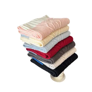 Folded stack of colorful soft knitted scarves for winter warmth and Korean style fashion