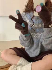 Detailed view of brown fluffy coral fleece gloves with light blue fingertips for winter