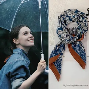 Close-up of French vintage paisley pattern silk scarf with elegant brown border detail