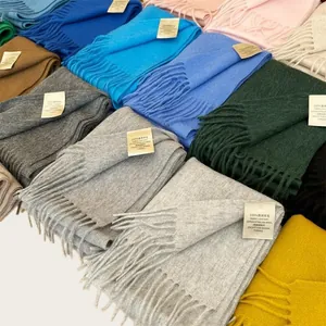 Close-up showing a collection of 100% Australian wool scarves in various vibrant colors.