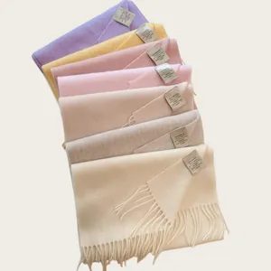 Macro detail of 100% Australian wool scarves in various soft pastel colors for winter