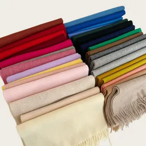 Collection of soft 100% wool scarves in multiple vibrant colors with tassel details