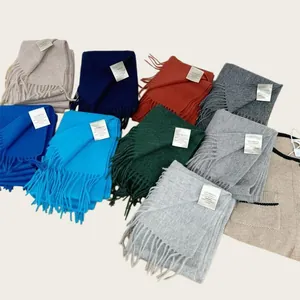 Detailed view of colorful 100% Australian wool scarves with quality composition labels.