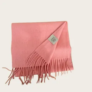Close-up detail of soft pink 100% Australian wool scarf with elegant tassels