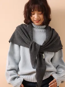 Detailed view of 100% wool knitted triangle shawl showing soft texture and styling