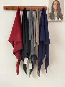 Detailed view of 100% Australian wool knitted triangle shawls in various colors