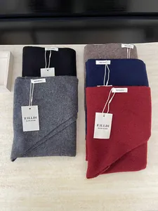 Detailed view of multiple 100% Australian wool knitted triangle shawls in various colors