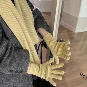 Detailed view of pale yellow ribbed knit scarf and gloves gift set for women
