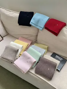 Cozy multi-color knitted scarves with delicate metal labels for autumn and winter