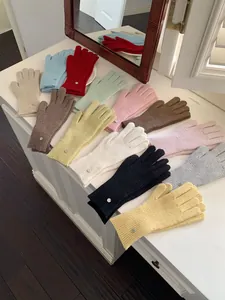 Variety of colorful solid knitted wool gloves for women in a warm winter gift set