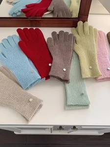 A collection of cozy solid color knitted gloves in a variety of vibrant and pastel shades